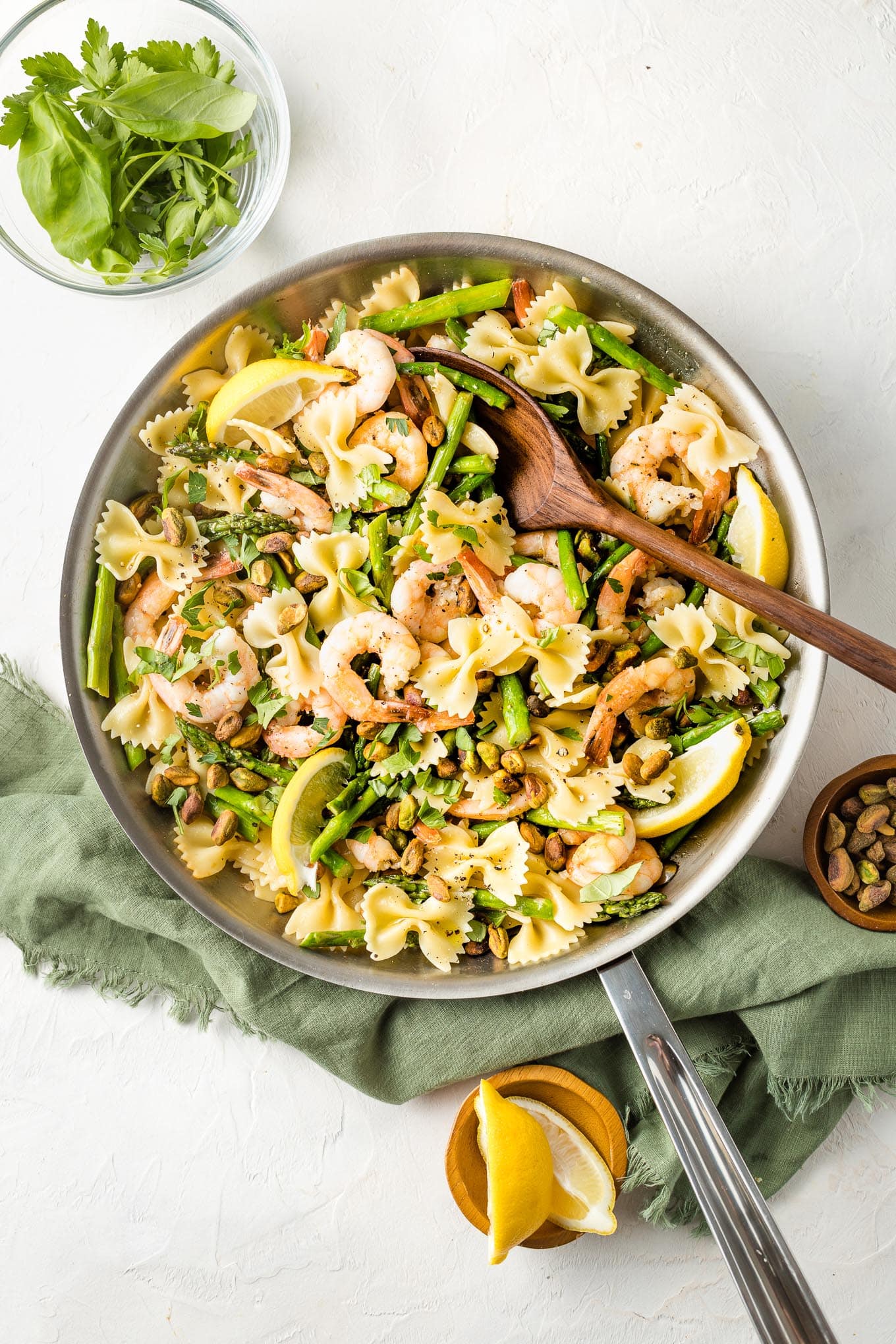 Skillet with lemon asparagus pasta with shrimp and pistachios.