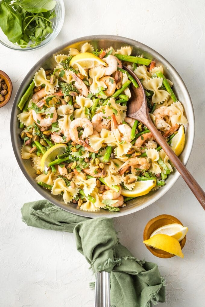 Skillet with lemon asparagus pasta with shrimp and pistachios.