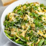 Close up of pasta noodles with spring veggies.