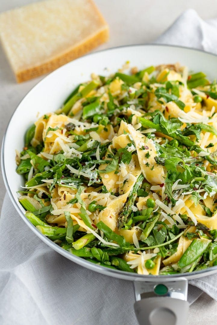 Close up of pasta noodles with spring veggies.