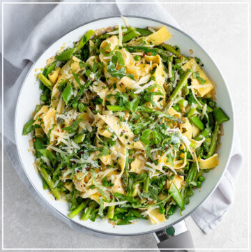 Skillet filled with creamy pasta Primavera.