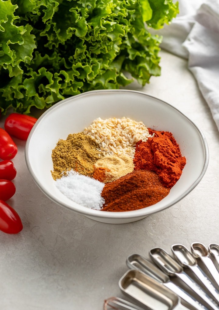 All the spices in homemade taco seasoning arranged in neat piles in a bowl.