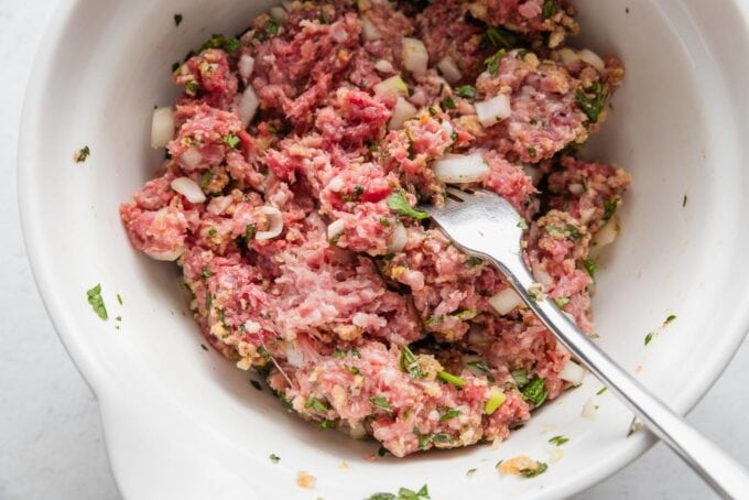 Lamb and beef meatball mixture, combined gently with a fork.