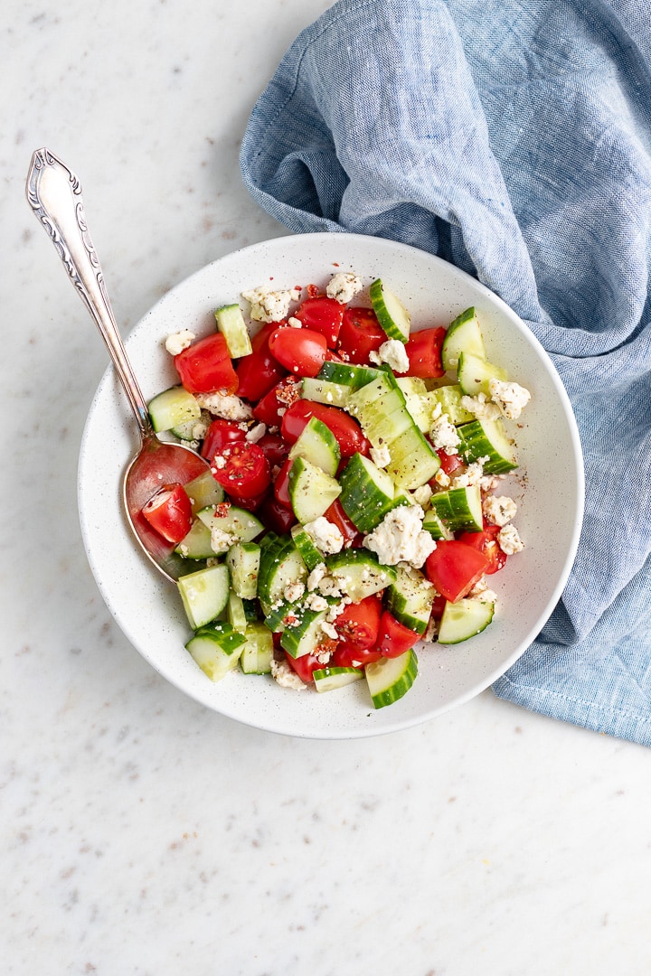 Photo of tomato cucumber salad with feta, ready to serve.