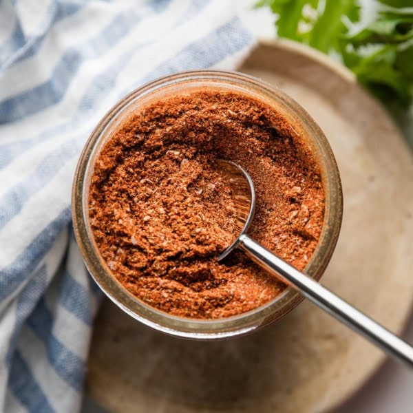 Close up of homemade taco seasoning in a jar.