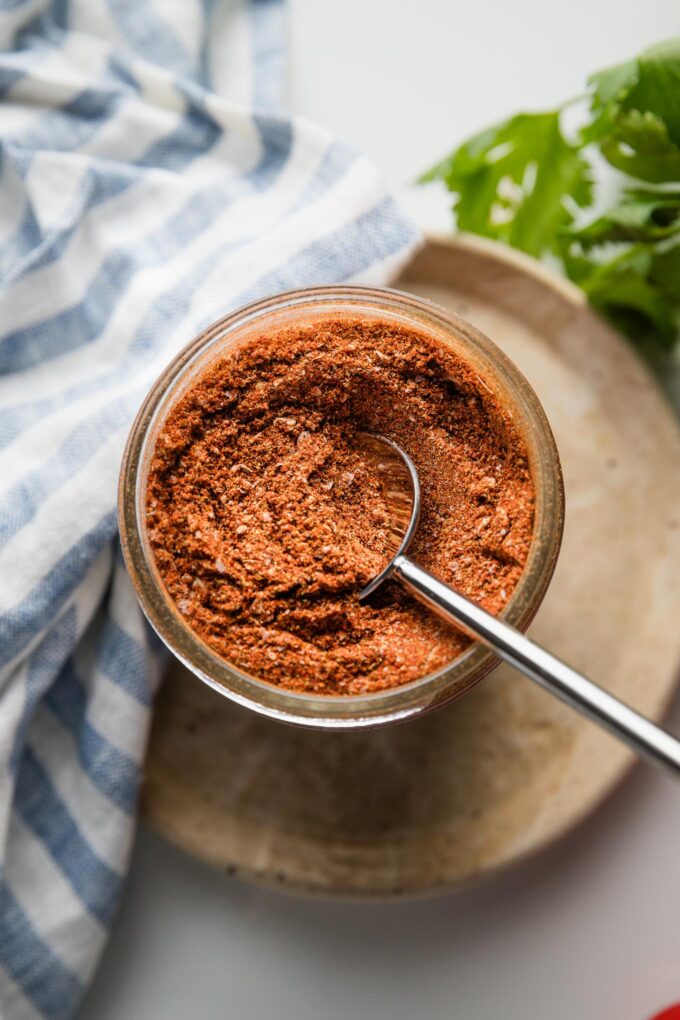 Close up of homemade taco seasoning in a jar.