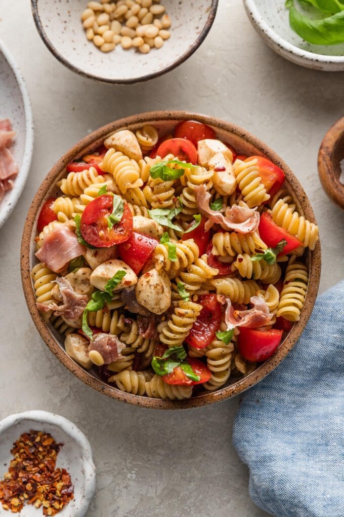 Bowl full of a serving of caprese pasta salad.