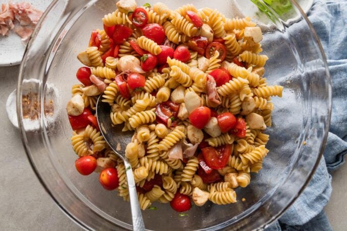 Pasta added to light salad with mozzarella and tomatoes.
