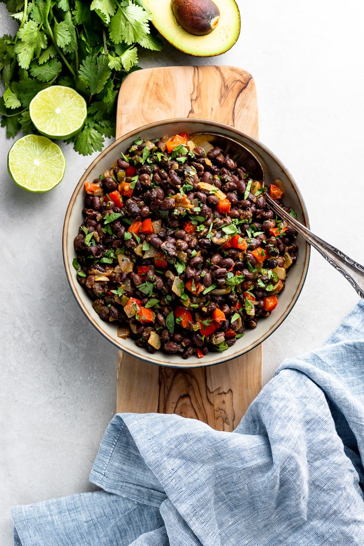 Bowl filled with spicy black beans ready to serve as a side dish.