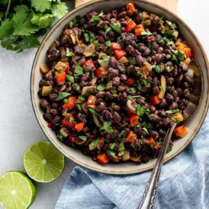 Bowl filled with spicy black beans ready to serve as a side dish.