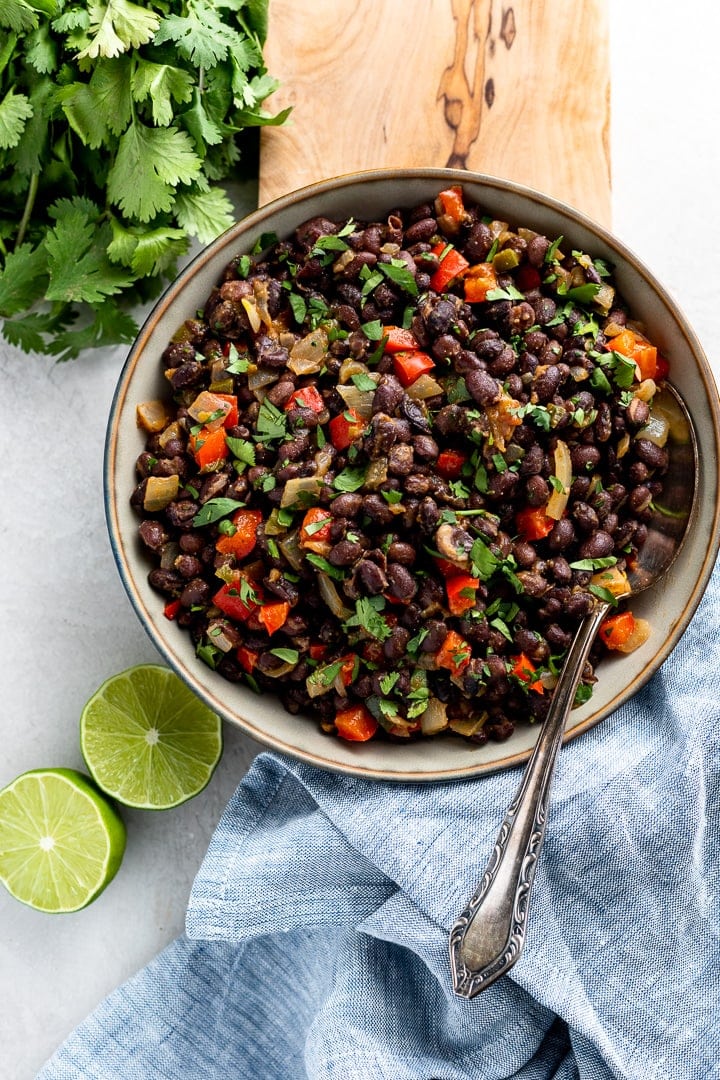 Bowl filled with spicy black beans ready to serve as a side dish.