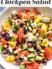 This easy and versatile chopped Greek Chickpea Salad takes less than 20 minutes to make and is packed with vibrant Mediterranean flavors. Loaded with crunchy bell peppers and cucumbers, briny olives, creamy Feta, and a light homemade vinaigrette, you’ll love this as a side, lunch, or dish to share.