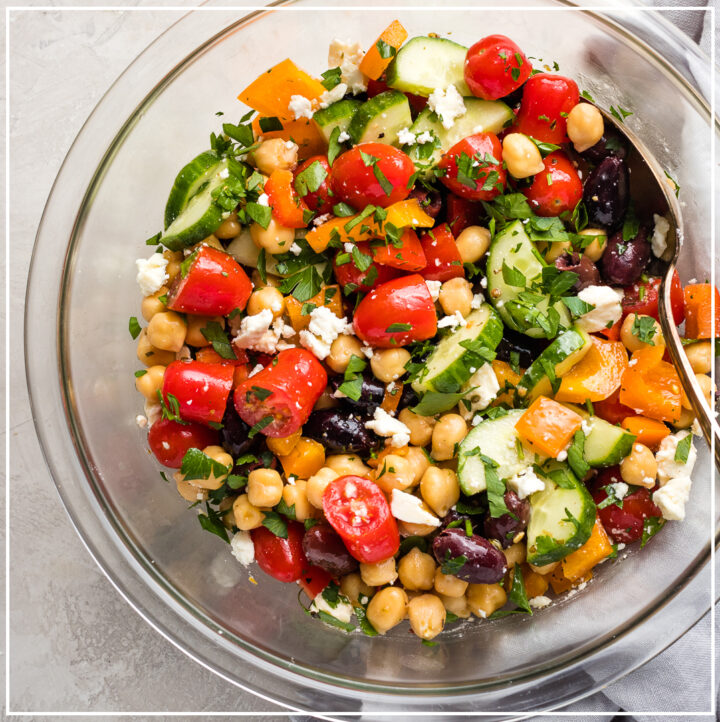 A large serving bowl filled with Greek chickpea salad.