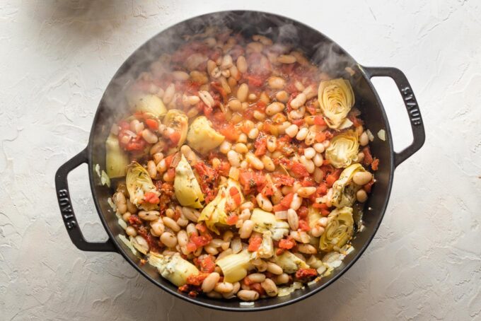 Steam rising as liquid cooks off of skillet.