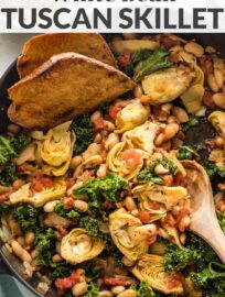 Spice up your dinner routine with this easy Tuscan white bean skillet. Ready in under 30 minutes, perfect with a crusty loaf of bread! A delicious, easy dinner recipe that happens to be casually vegan.