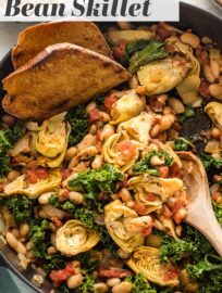 Spice up your dinner routine with this easy Tuscan white bean skillet. Ready in under 30 minutes, perfect with a crusty loaf of bread! A delicious, easy dinner recipe that happens to be casually vegan.