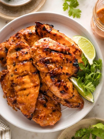 Small plate filled with grilled honey chipotle chicken breasts.