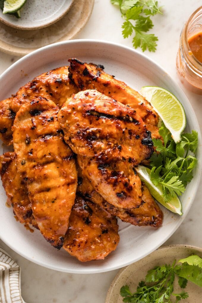 Small plate filled with grilled honey chipotle chicken breasts.