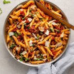 Skillet filled with penne alla vodka with mushrooms and sun-dried tomatoes.