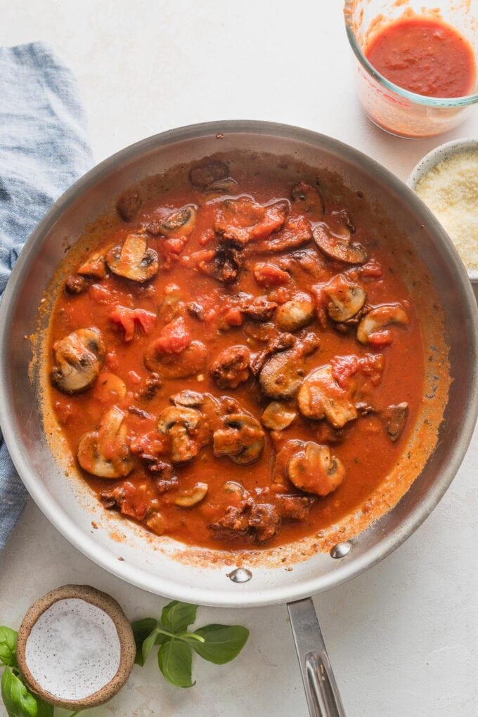Vodka sauce simmering with mushrooms and sun-dried tomatoes mixed in.