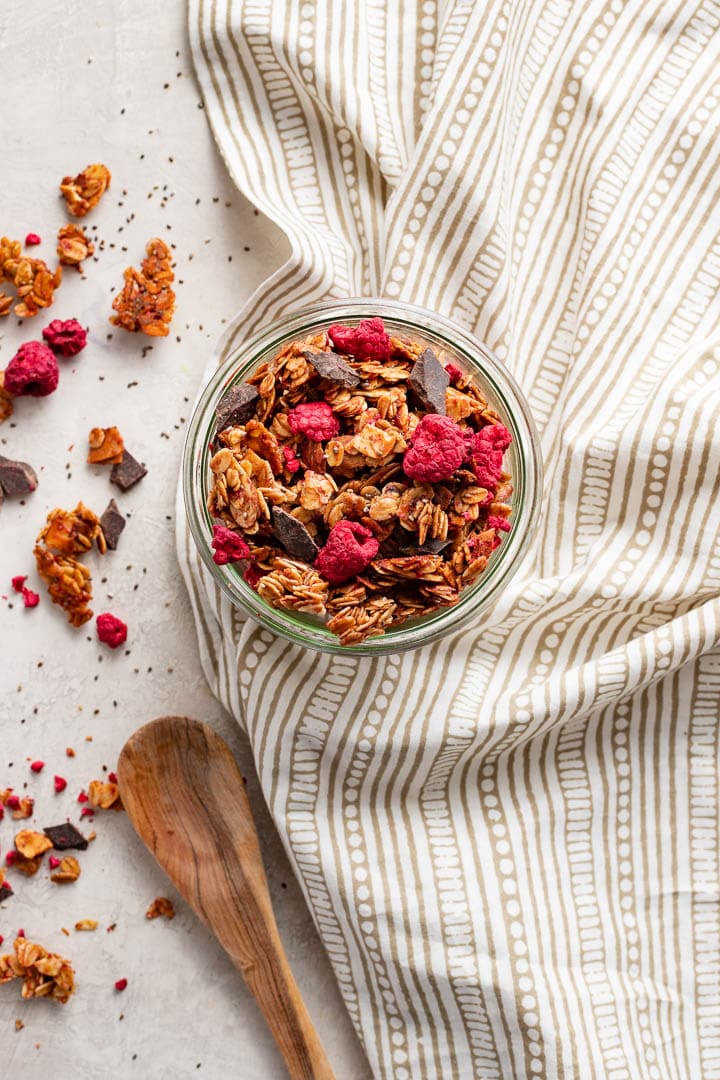 A small jar filled with raspberry chocolate chunk granola.