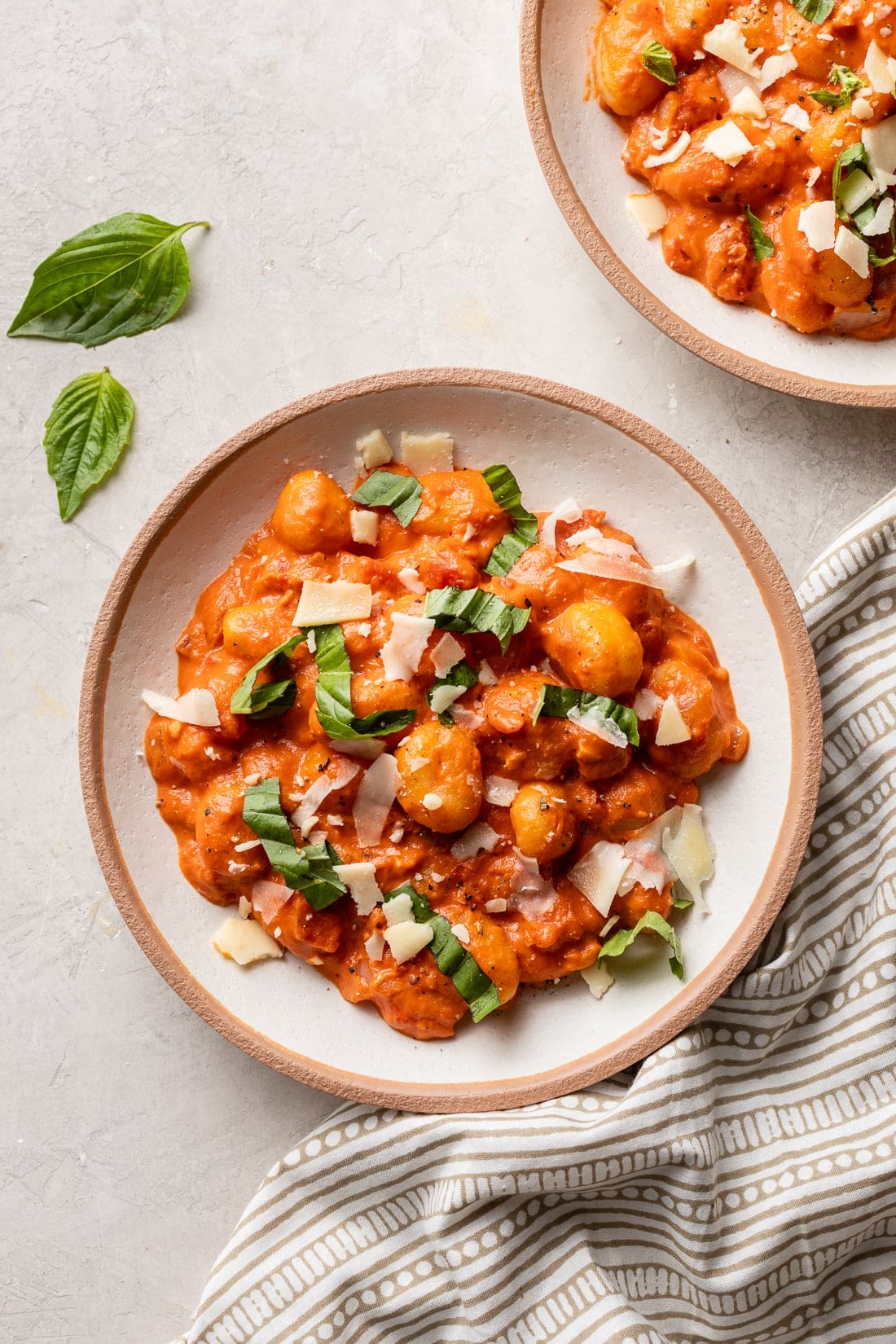 Bowls filled with comforting gnocchi alla vodka, Parmesan, and basil.