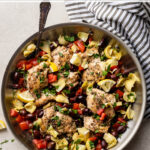 Enjoy Mediterranean cooking any weeknight with this easy 30-minute recipe for Greek chicken thighs with olives, tomatoes, and artichokes. This packs a ton of flavor into just one skillet, so cooking and clean-up are both a breeze. And with a few simple tricks, you'll learn how to deliver perfectly tender chicken each and every time. #greekchicken #easychickenrecipes #mediterraneanrecipes