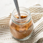 A small glass jar filled with homemade pumpkin pie spice.