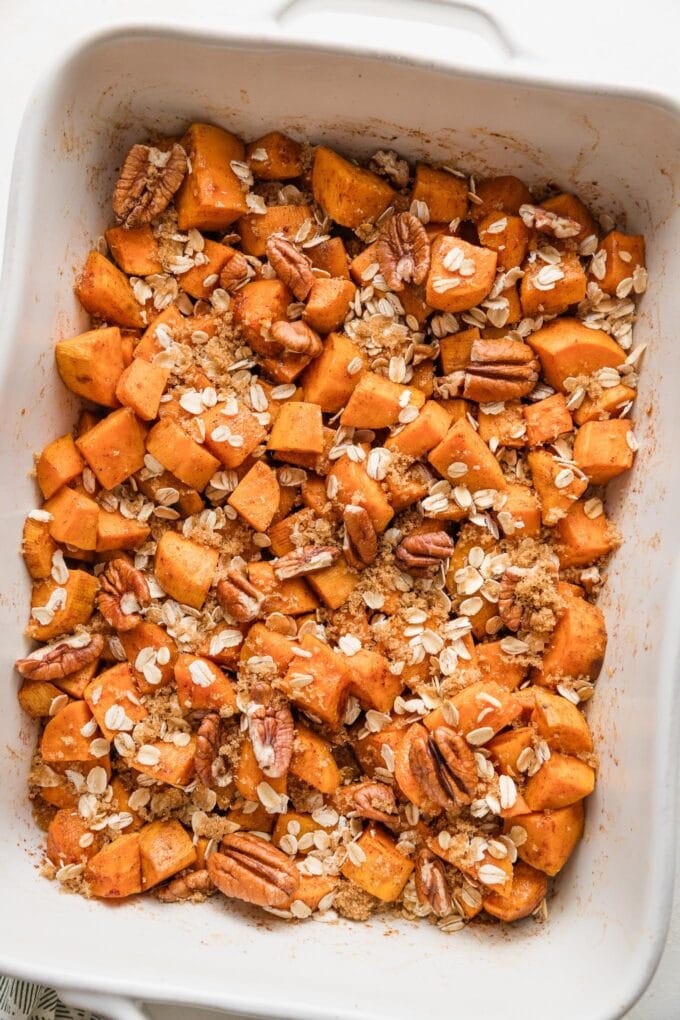 Pan of cubed sweet potatoes with oat pecan topping just pulled out of the oven.