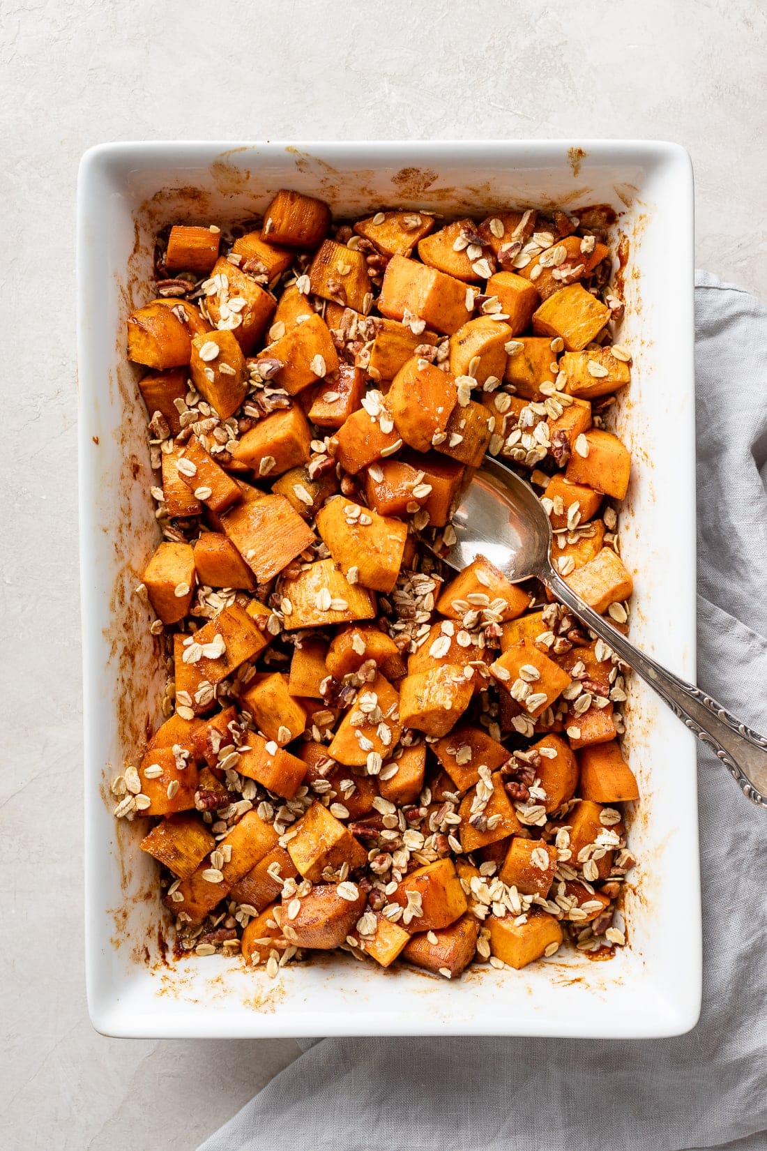 Baking dish filled with baked honey butter sweet potatoes.