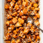 This classic and easy sweet potato recipe is sure to please everyone! Baked with cinnamon honey butter and an optional topping of oats and pecans, this is a classic side dish for Thanksgiving or any holiday, but equally suited to serve alongside roast chicken for an easy but tasty everyday meal. #sweetpotato #sidedish #thanksgivingrecipes