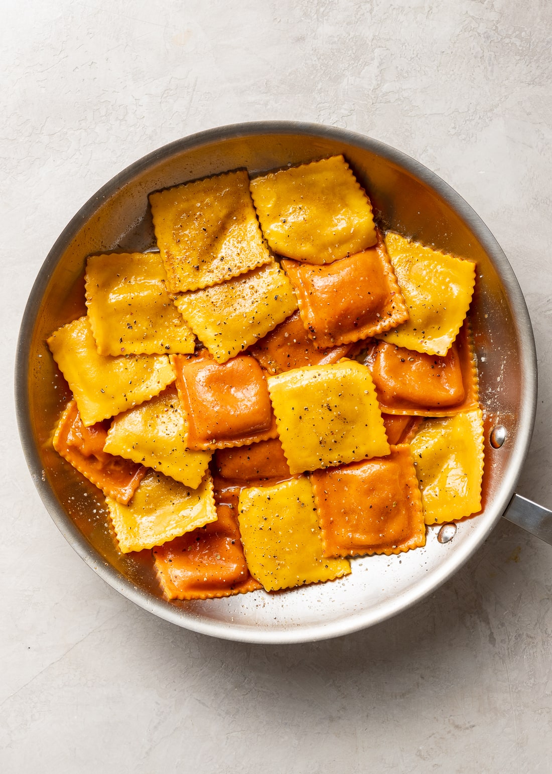 Ravioli added to the skillet with the brown butter sauce.