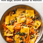 This easy recipe elevates store-bought pumpkin ravioli with sage brown butter sauce, toasted walnuts, and a surprise finishing touch. Seriously the best way to use Trader Joe's pumpkin ravioli! This is a dreamy fall dinner, and best of all it takes just 25 minutes! #pumpkinravioli #traderjoes #falldinnerrecipes