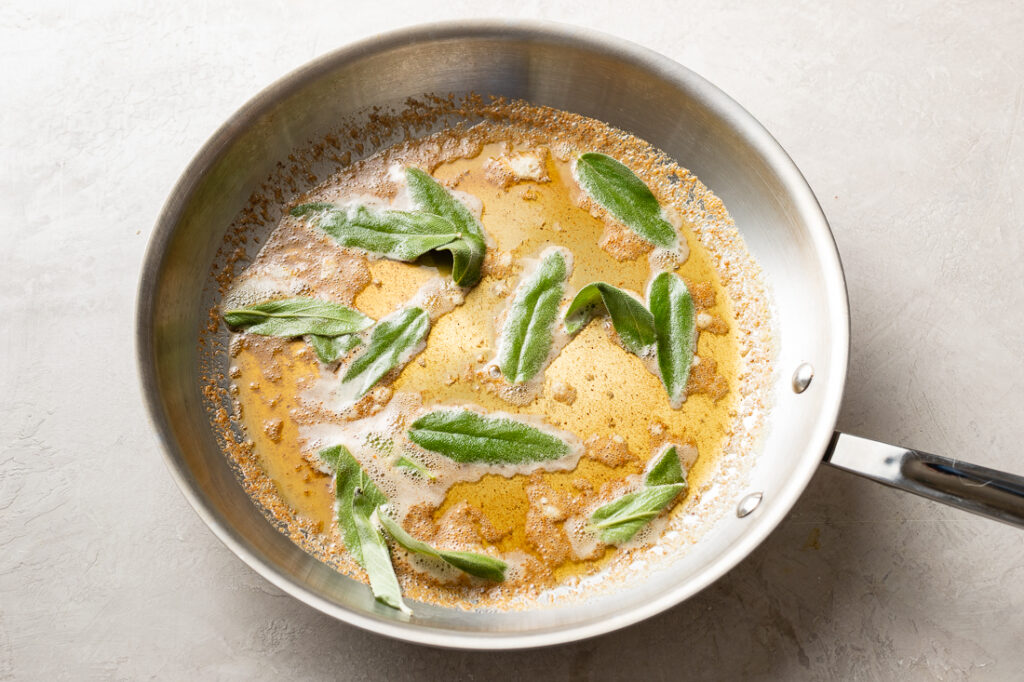 Sage leaves crisping in the skillet.