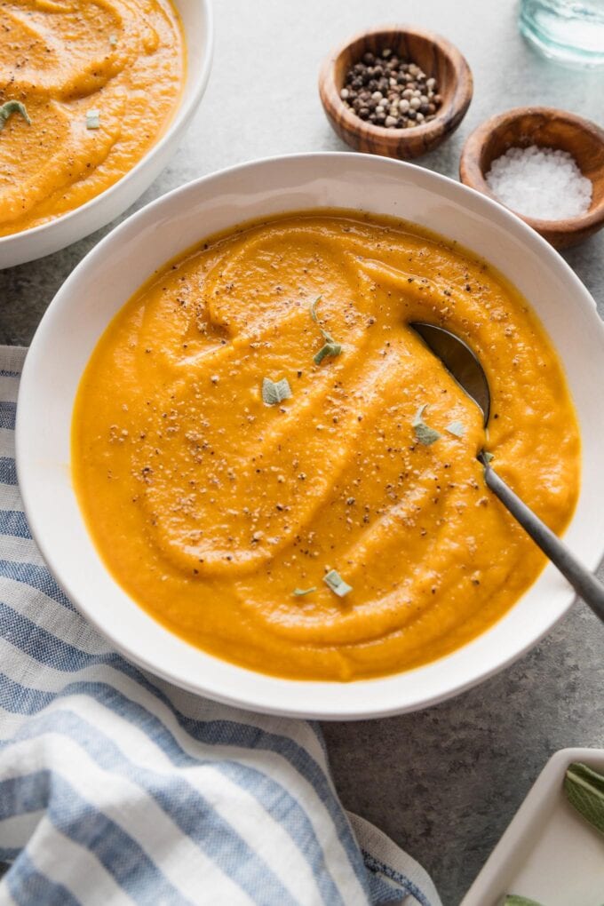 Angled view of a bowl of smooth, velvety roasted butternut squash soup.