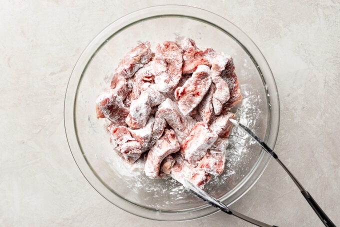 Pieces of flank steak coated in corn starch.