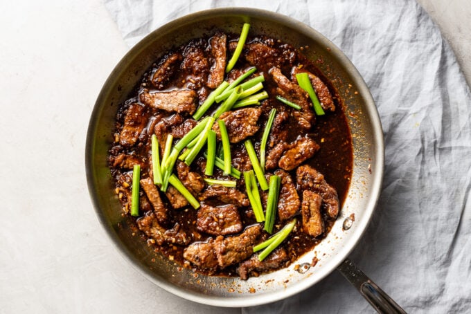 A skillet full of finished Mongolian beef.