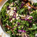 Healthy and easy kale Brussels sprout salad with red cabbage, sliced almonds, and lemon Parmesan dressing..