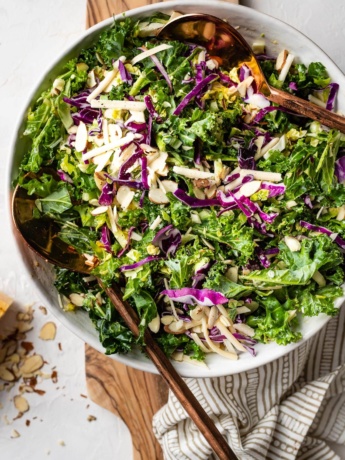 Healthy and easy kale Brussels sprout salad with red cabbage, sliced almonds, and lemon Parmesan dressing..