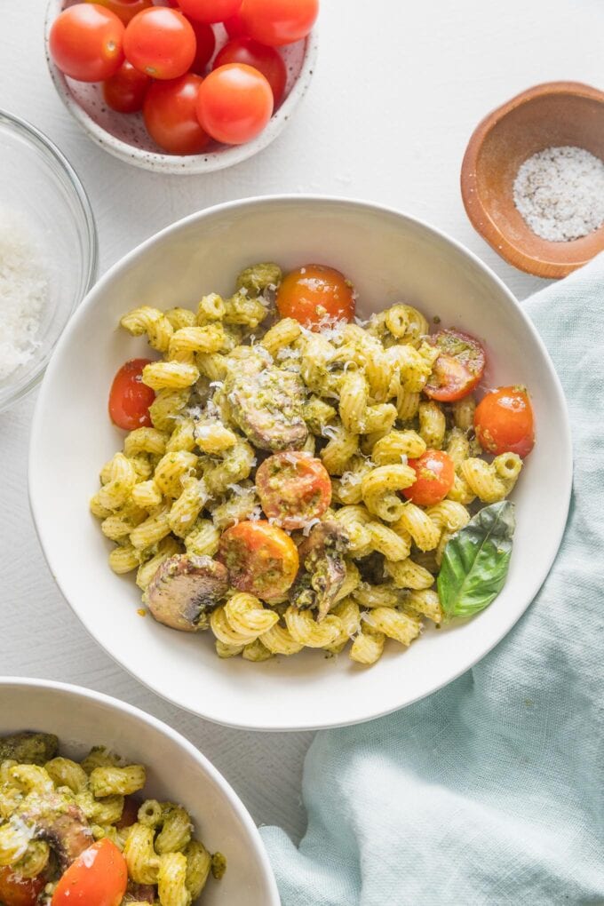 Small white bowl filled with a portion of homemade pesto cavatappi.