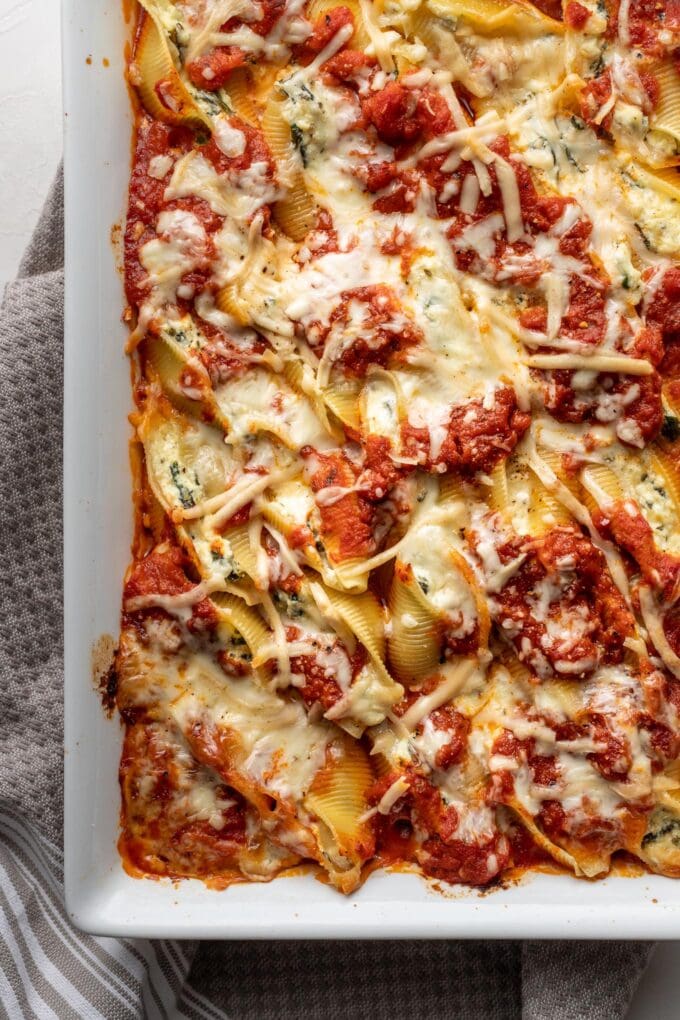 Overhead image of stuffed shells with melted cheese on top.