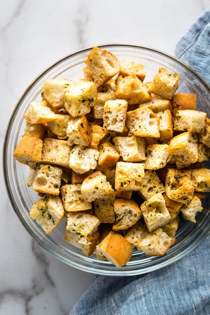 Crunchy homemade croutons in a clear bowl.