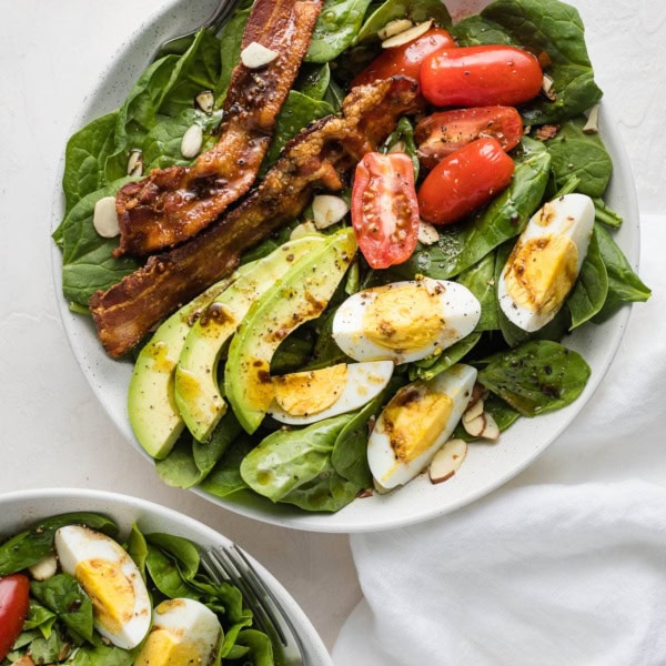 Spinach salad with bacon and eggs.