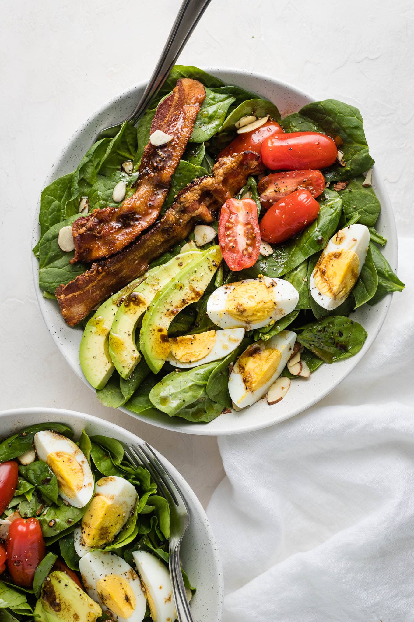 Spinach salad with bacon and eggs.