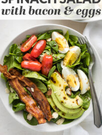 A hearty spinach salad with bacon and hard-boiled eggs is super satisfying without weighing you down! This easy recipe with tender greens, crisp bacon, juicy tomatoes, and a tangy vinaigrette is a modern take on a classic that's equal parts good and good-for-you.