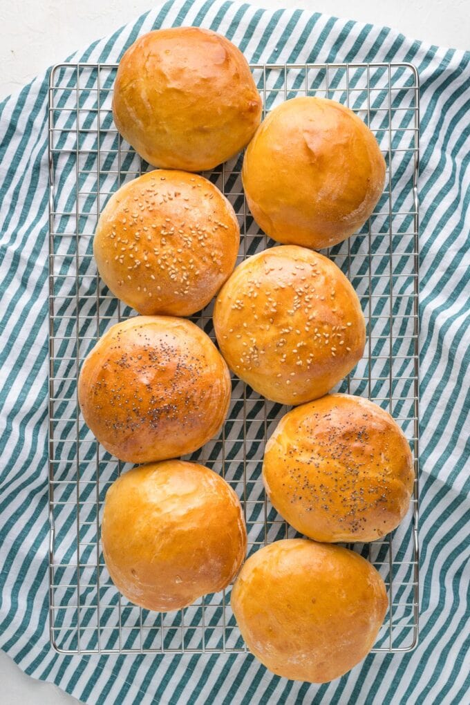 Finished hamburger buns on a cooling rack.