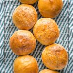 Finished hamburger buns on a cooling rack.