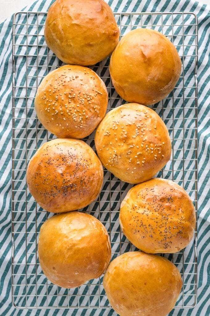 Finished hamburger buns on a cooling rack.