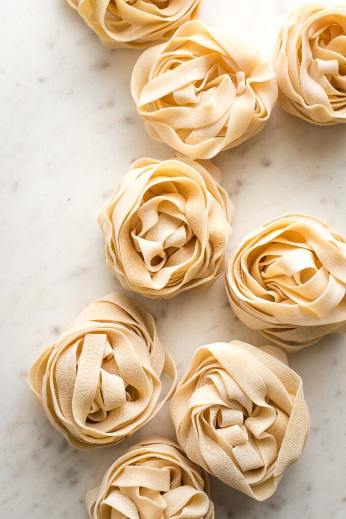 Nests of dried pappardelle pasta.