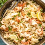 Large skillet filled with lemon pepper shrimp and pasta, ready to serve.